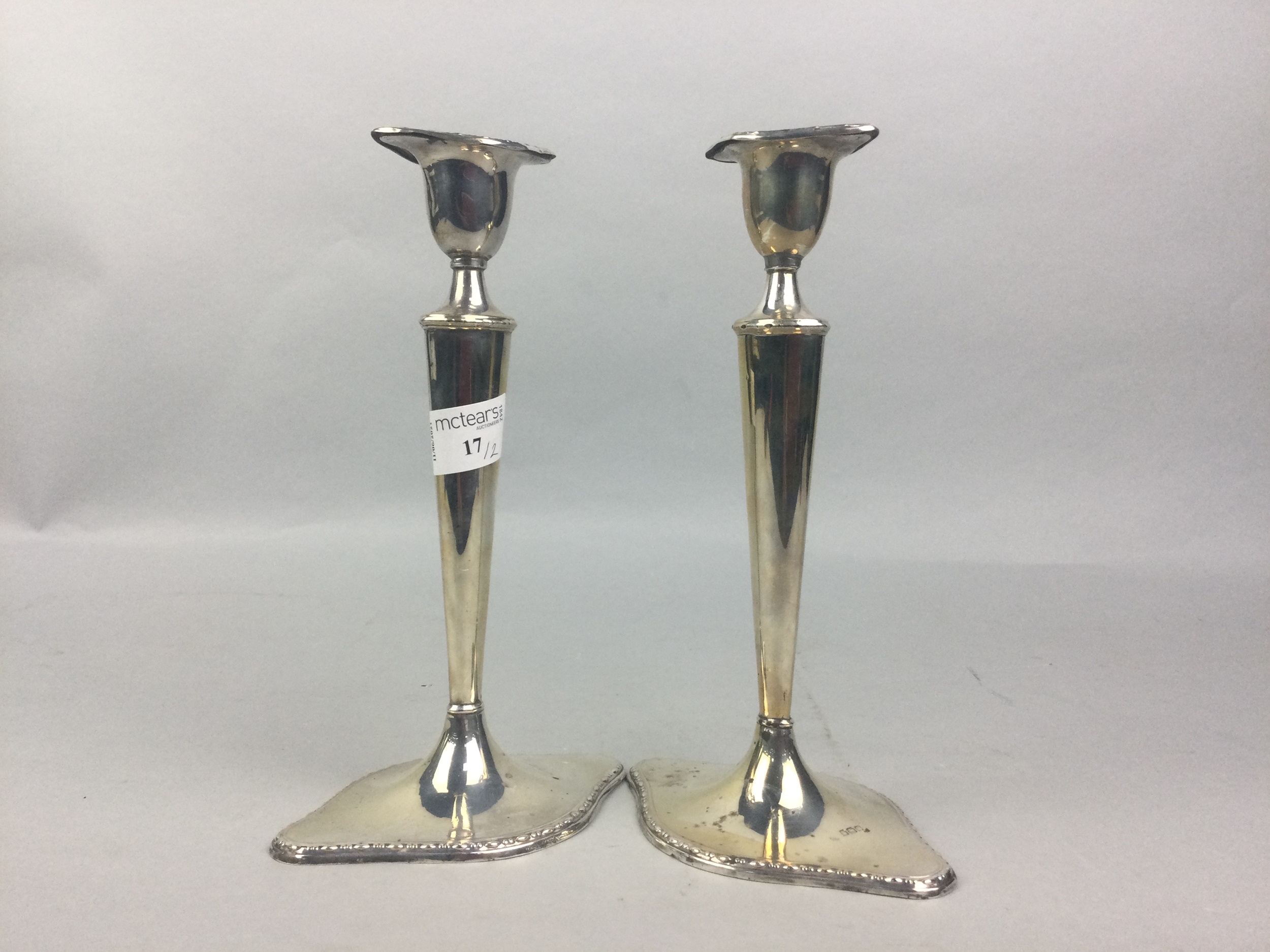 A PAIR OF SILVER CANDLESTICKS