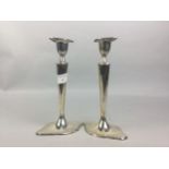 A PAIR OF SILVER CANDLESTICKS