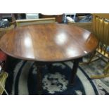 AN OAK DROP LEAF DINING TABLE