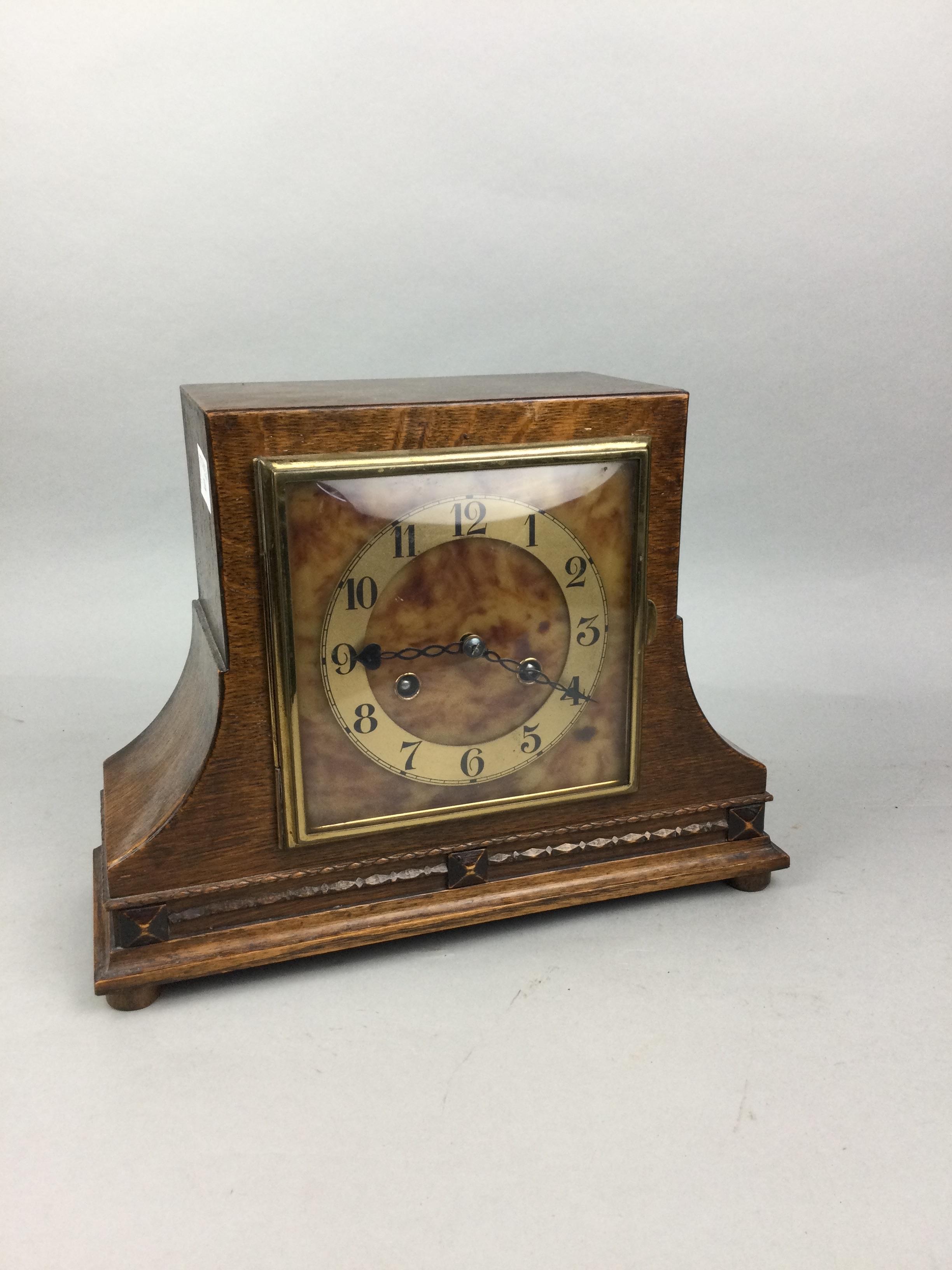 AN OAK CASED MANTEL CLOCK