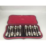 A CASED SET OF TWELVE SILVER SPOONS AND TONGS