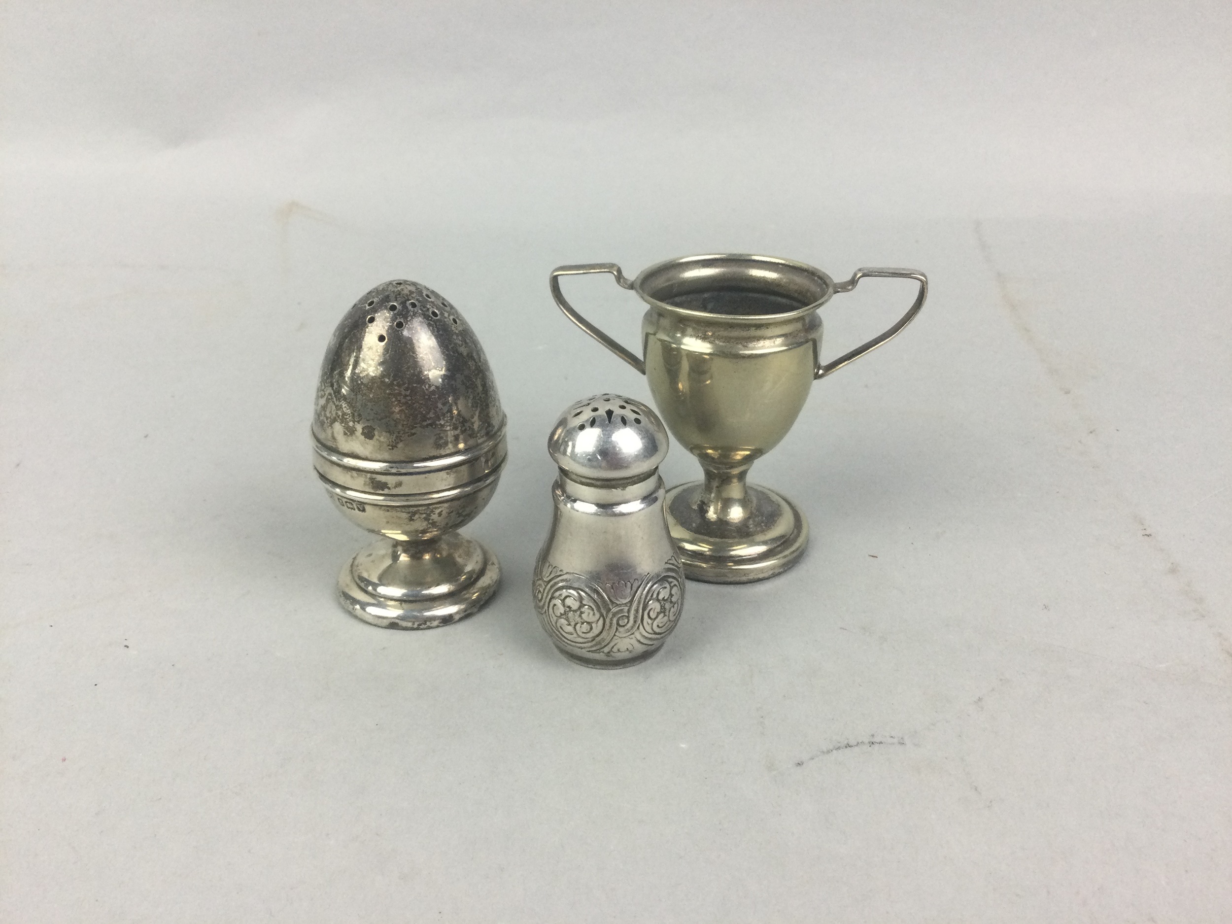 A SILVER PRIZE CUP AND TWO CRUETS