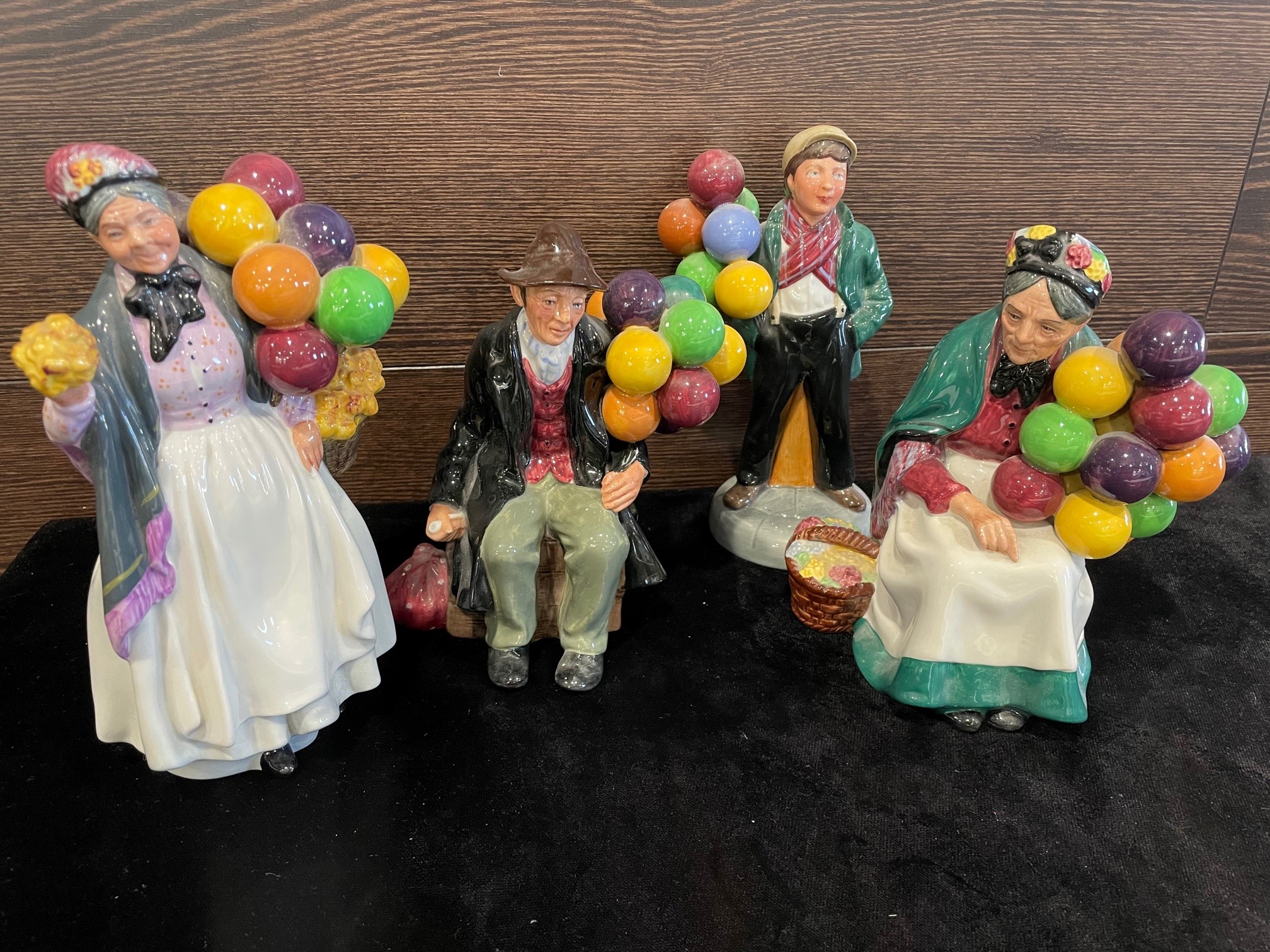 A ROYAL DOULTON FIGURE OF 'THE BALLOON MAN' AND FOUR OTHERS