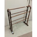 AN EARLY 20TH CENTURY MAHOGANY TOWEL RAIL