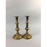 A PAIR OF VICTORIAN BRASS BINOCULARS AND BRASS CANDLESTICKS