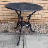 A METAL CIRCULAR BISTRO TABLE