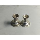 A PAIR OF SILVER CANDLESTICKS