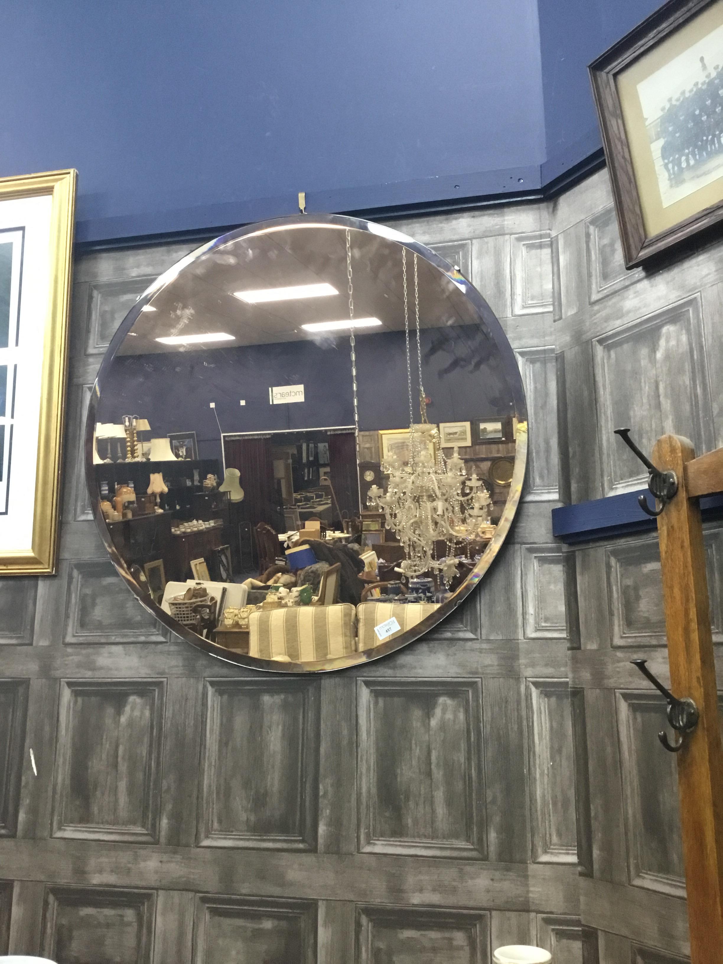 A CIRCULAR BEVELLED WALL MIRROR