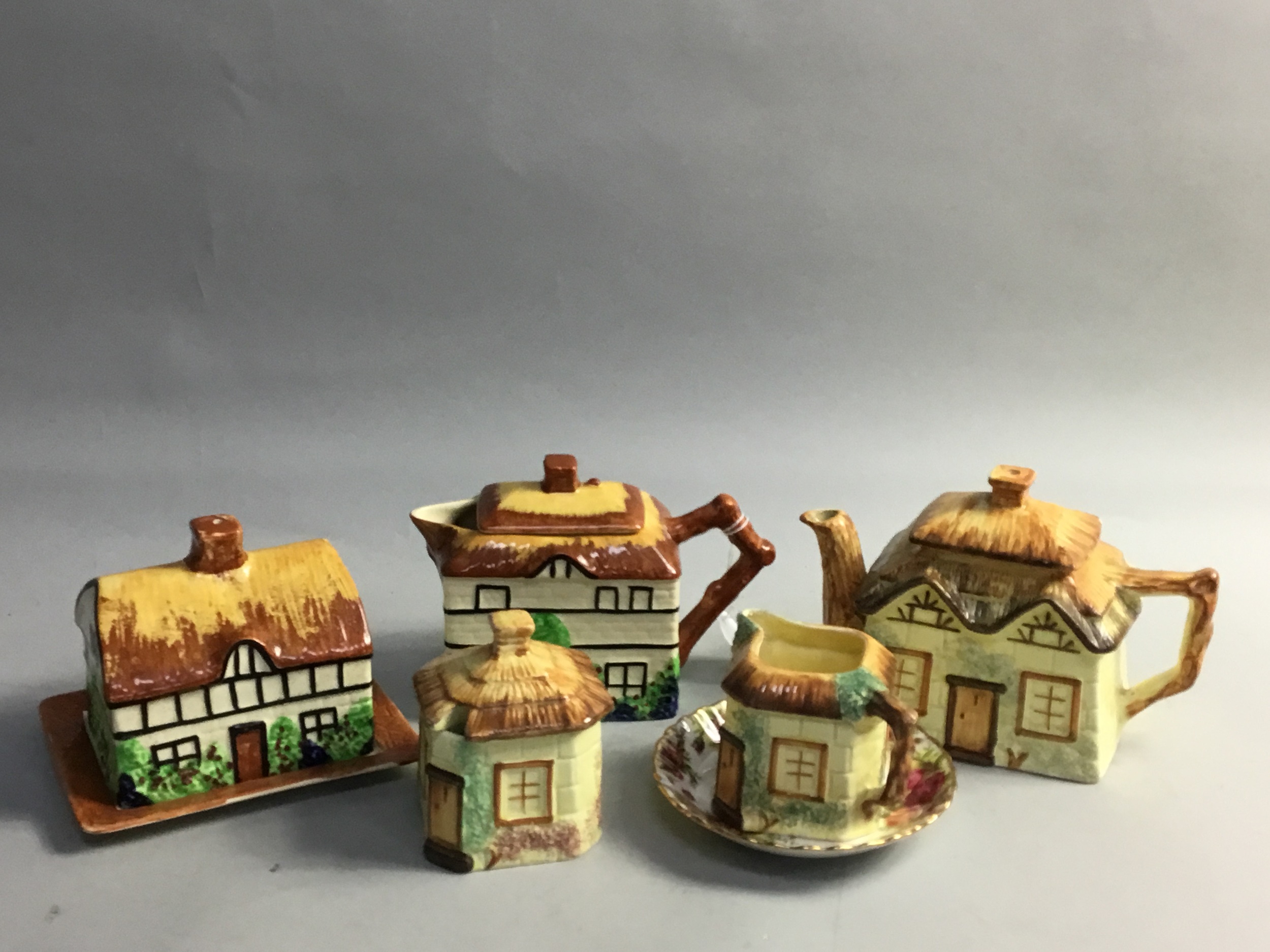 A NOVELTY THATCHED COTTAGE TEA WARE