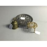 A BRASS TABLE BELL, SMALL STAND AND WHITE METAL CANDLE HOLDER