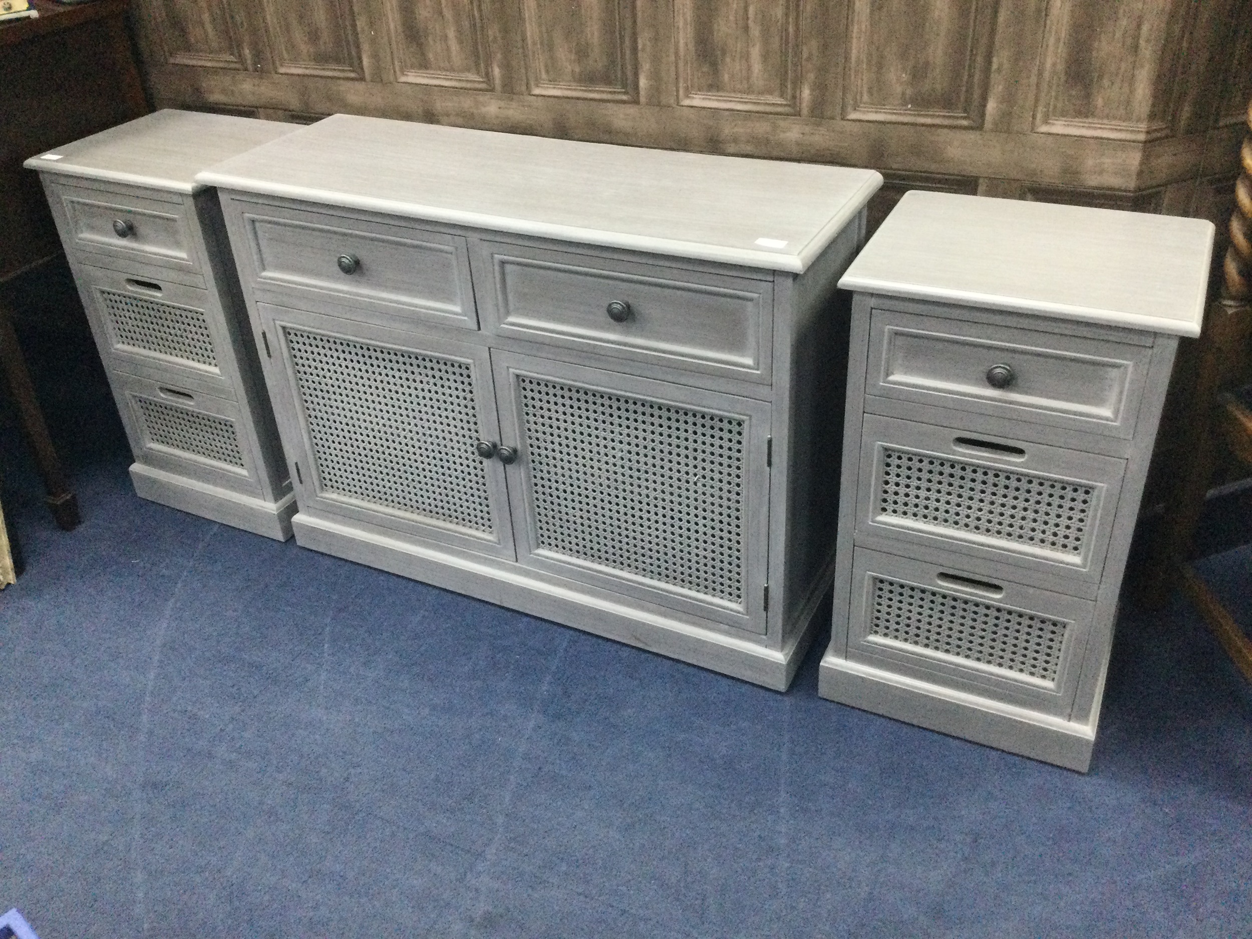 A GREY PAINTED CUPBOARD AND A PAIR OF BEDSIDE CHESTS