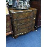 A REPRODUCTION WALNUT SERPENTINE FRONT CHEST OF FOUR DRAWERS