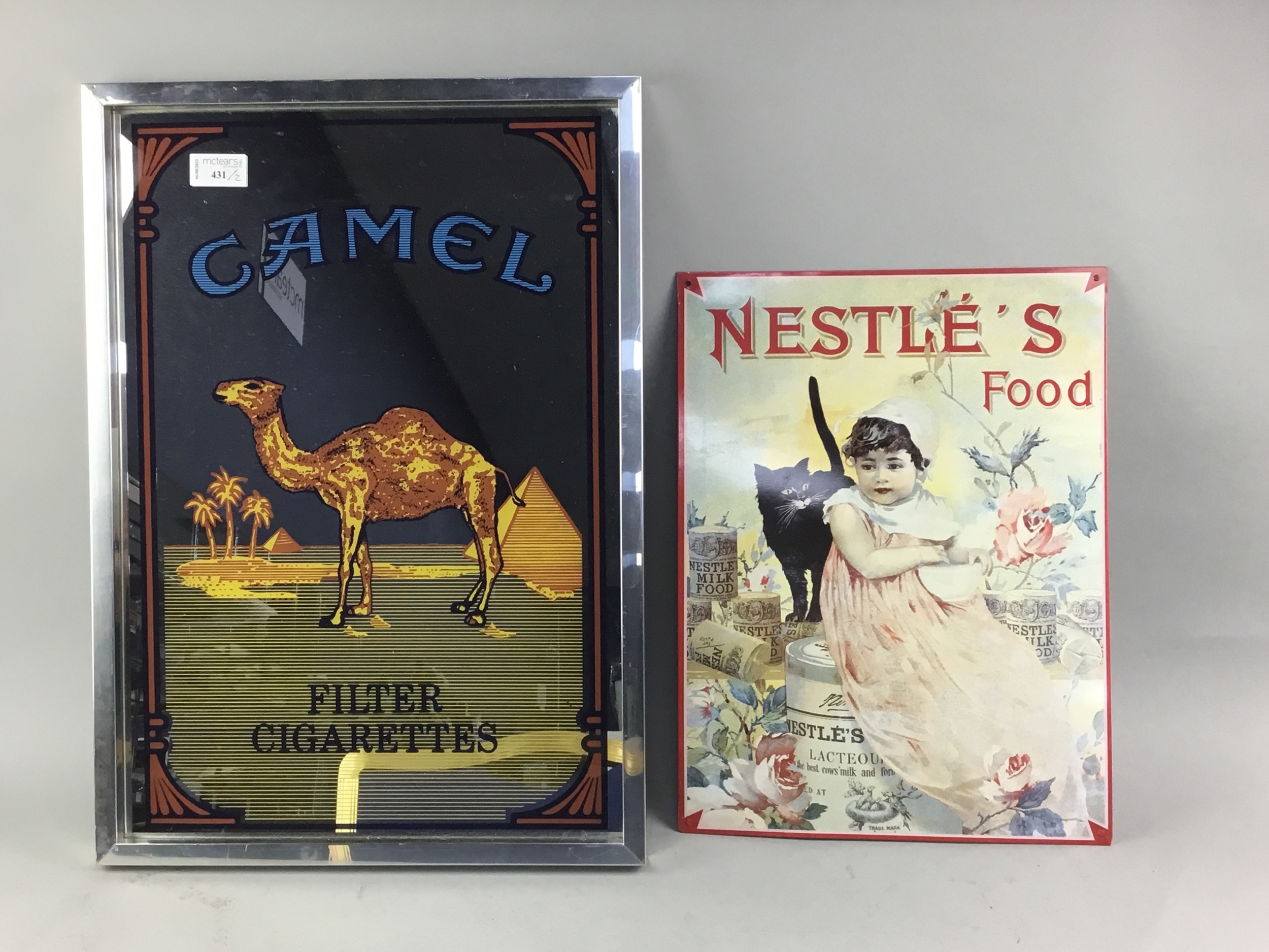 A CAMEL CIGARETTES ADVERTISEMENT MIRROR, ALONG WITH A NESTLE EXAMPLE