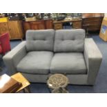 A MODERN GREY UPHOLSTERED TWO SEAT SETTEE SOFA BED AND MATCHING SNUGGLER