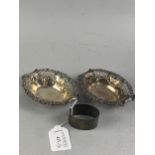 A PAIR OF PIERCED SILVER DISHES AND A SILVER NAPKIN RING