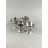 A SET OF FOUR SMALL SILVER THREE HANDLED CUPS