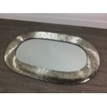 A MODERN OVAL WALL MIRROR IN A MIRRORED MOSAIC TYPE FRAME