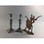 A PAIR OF SILVER PLATED PLATED CANDLESTICKS AND A FIGURE GROUP