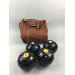 A SET OF FOUR LAWN BOWLS