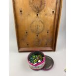 A BAGATELLE BOARD ALONG WITH A COLLECTION OF MARBLES