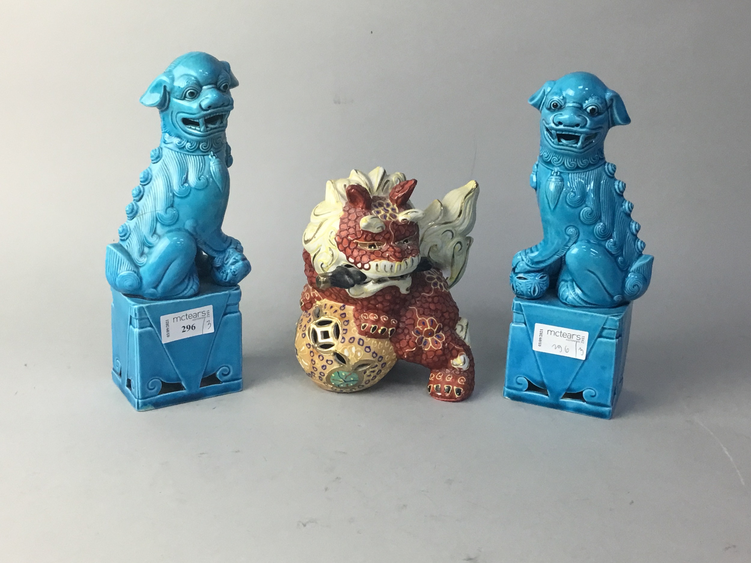 A PAIR OF CHINESE TURQUOISE GLAZED FOE DOGS AND ANOTHER