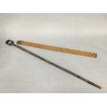 A FOLDING BOXWOOD FIVE FOOT MEASURING STICK AND A TRIBAL WALKING STICK