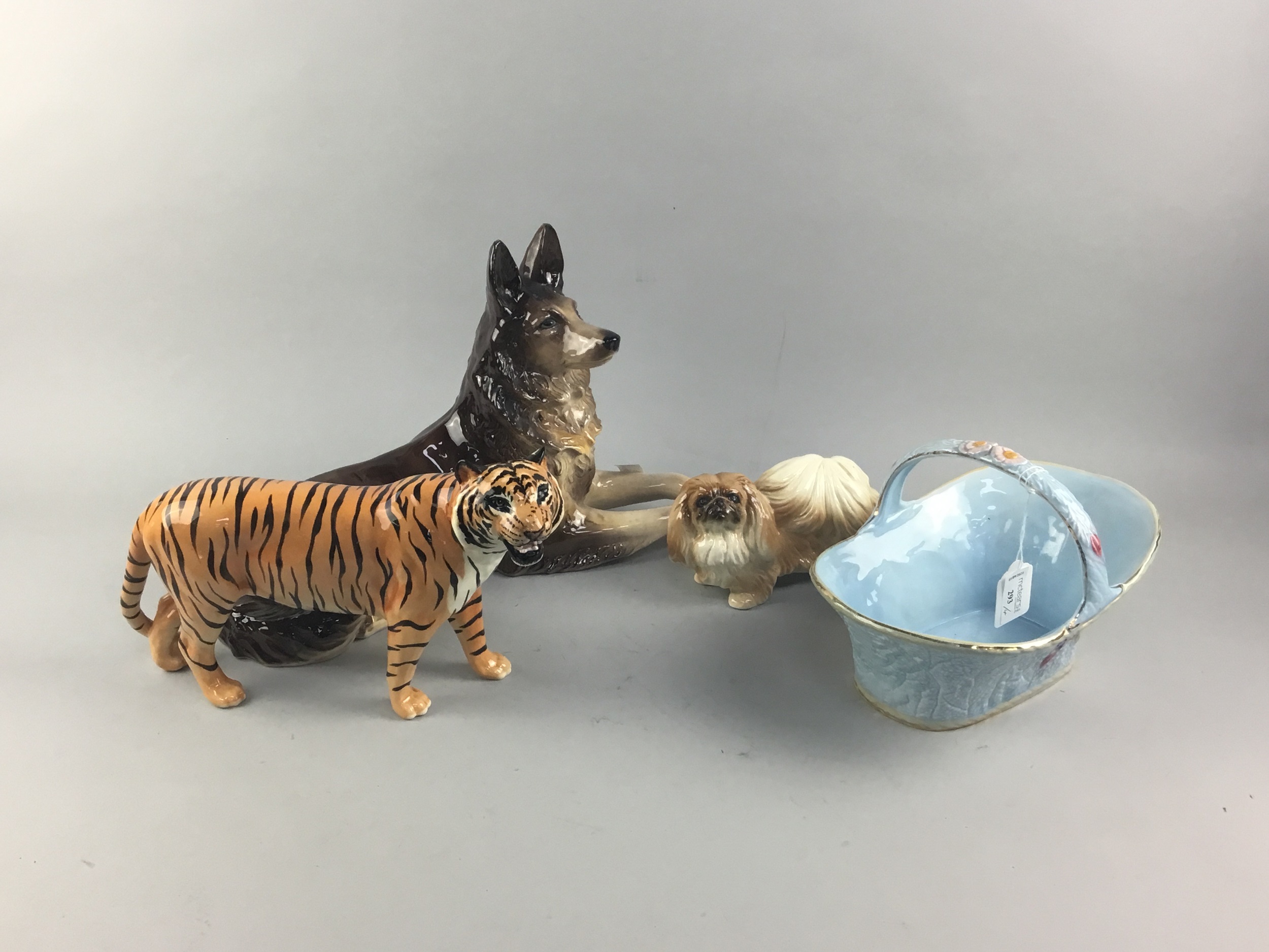 A BESWICK FIGURE OF A TIGER, TWO DOG FIGURES AND A MELBA POTTERY BASKET