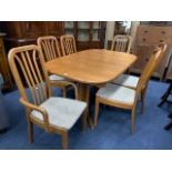 A MODERN DINING TABLE WITH SIX DINING CHAIRS