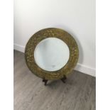 A HAMMERED BRASS MIRROR