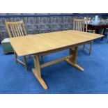 AN ERCOL BLONDE OAK DINING TABLE AND SIX CHAIRS