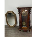 AN OAK WALL CLOCK AND A BRASS EMBOSSED WALL MIRROR