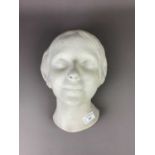 A STUCCO SCULPTURE OF A FEMALE HEAD