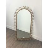 AN ARCHED BEVELLED WALL MIRROR