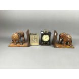A PAIR OF ELEPHANT BOOKENDS AND TWO MANTEL CLOCKS
