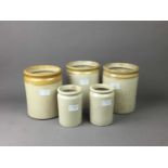 A LOT OF THREE STONEWARE CYLINDRICAL STORAGE JARS AND TWO OTHERS