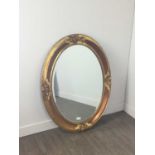 AN OVAL BEVELLED WALL MIRROR