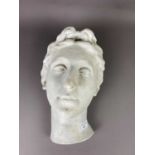 A STUCCO SCULPTURE OF A FEMALE HEAD