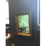 A GILT FRAMED WALL MIRROR