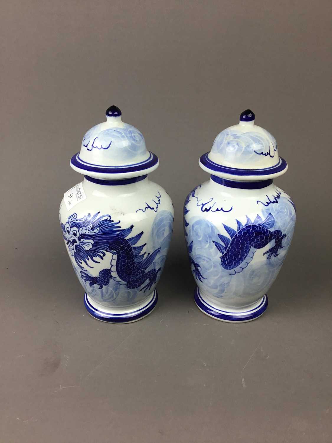 A PAIR OF CHINESE BLUE AND WHITE VASES AND COVERS