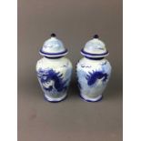 A PAIR OF CHINESE BLUE AND WHITE VASES AND COVERS