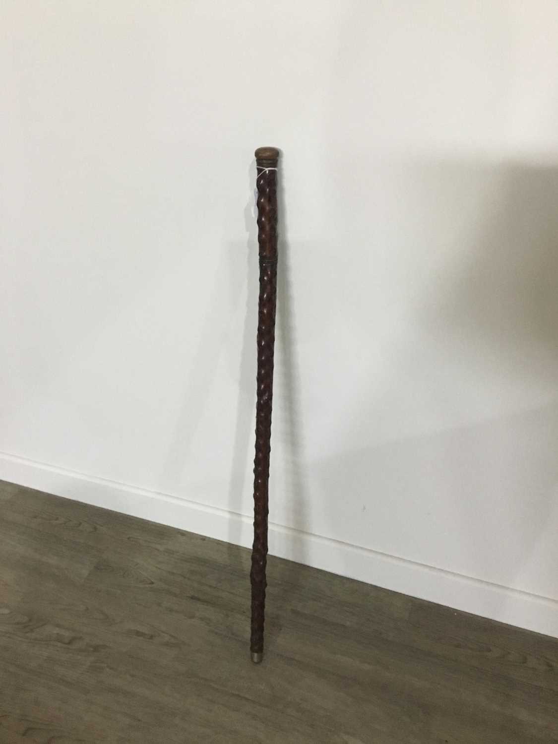 A CARVED WOOD WALKING STICK/FLASK