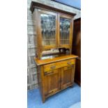 A LATE 19TH/EARLY 20TH CENTURY OAK BOOKCASE ON CHEST