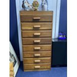 AN OAK PEDESTAL CHEST OF EIGHT DRAWERS