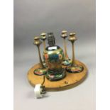 AN ART DECO WALL MIRROR, CANDLESTICKS AND A LAMP