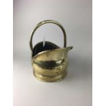 A HAMMERED BRASS COAL BUCKET ALONG WITH FIRESIDE COMPANION STAND