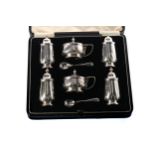 A GEORGE V SILVER SIX PIECE CRUET SET