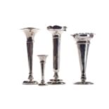 A EDWARDIAN SILVER TRUMPET VASE AND THREE OTHERS