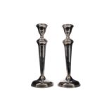 A PAIR OF GEORGE V SILVER CANDLESTICKS