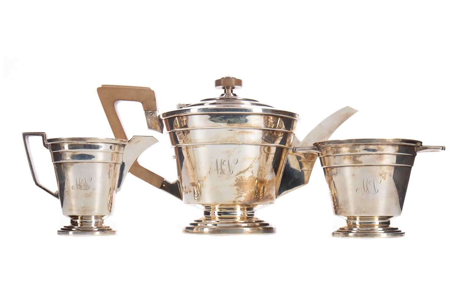 A GEORGE VI SILVER THREE PIECE TEA SERVICE OF ART DECO DESIGN