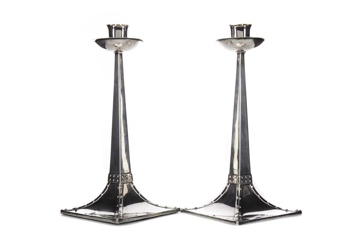A PAIR OF ARTS & CRAFTS SILVER CANDLESTICKS